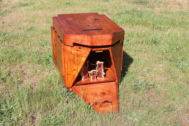 In addition to opening up top like a normal toy chest, this one opens up in the front like a Sandcrawler ought to.